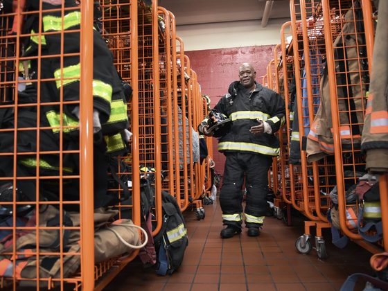 A firefighter in the gear room of a fire station